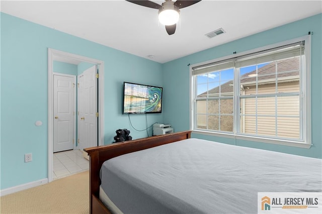 tiled bedroom with visible vents, carpet flooring, baseboards, and ceiling fan