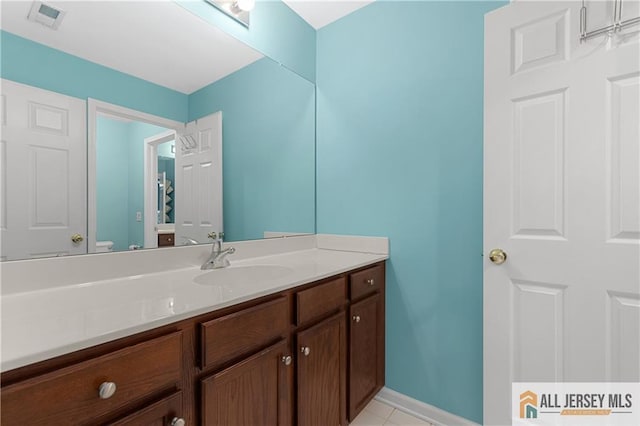 bathroom featuring baseboards, visible vents, tile patterned flooring, and vanity