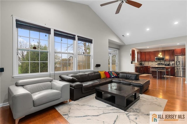 living area featuring recessed lighting, ceiling fan, a healthy amount of sunlight, and wood finished floors