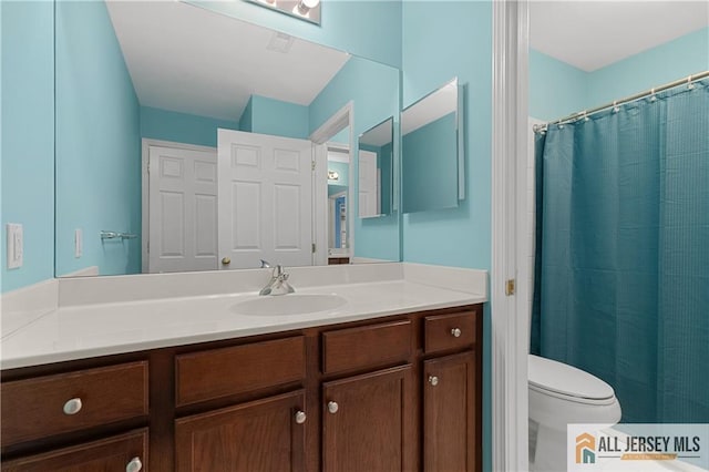 bathroom featuring vanity, a shower with curtain, and toilet