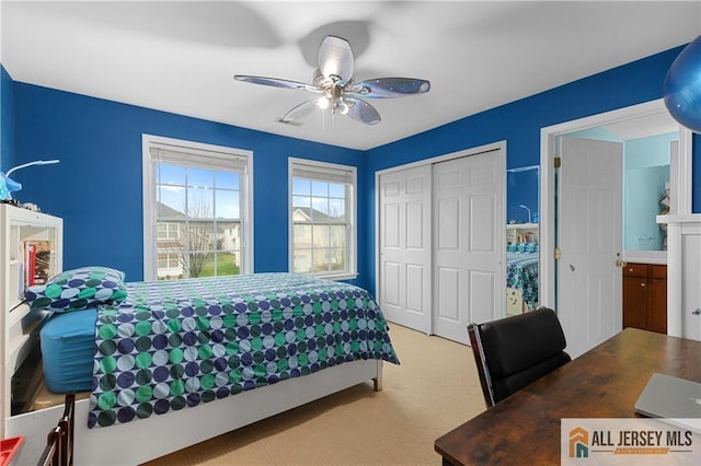 bedroom with a ceiling fan, a closet, and light colored carpet