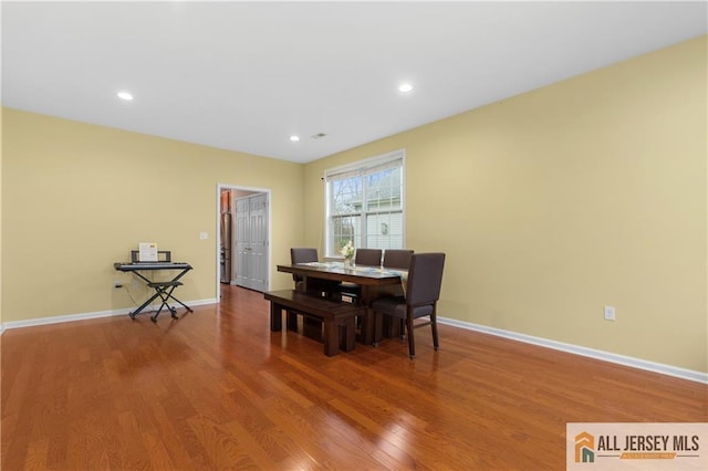 dining space with baseboards, recessed lighting, and wood finished floors