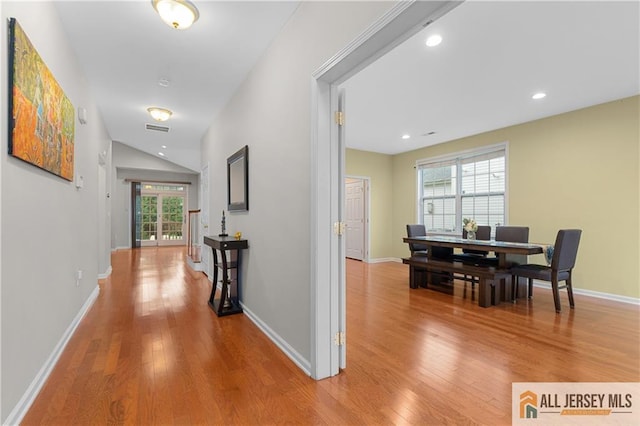 corridor featuring recessed lighting, baseboards, visible vents, and light wood-type flooring