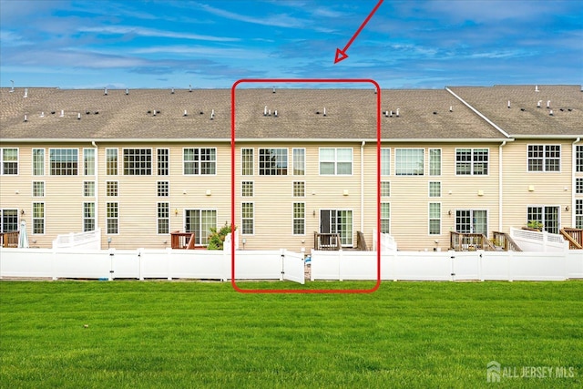 back of property with a shingled roof