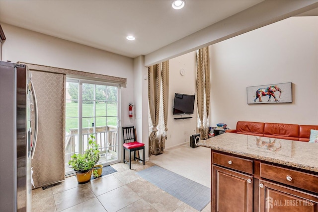bedroom with freestanding refrigerator, access to outside, light tile patterned floors, and recessed lighting