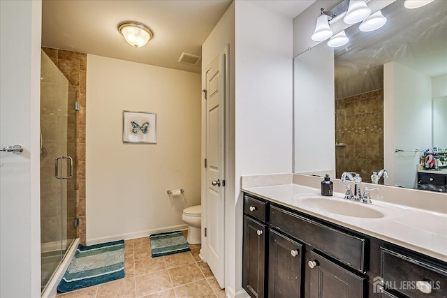 bathroom featuring a stall shower, toilet, tile patterned flooring, and vanity