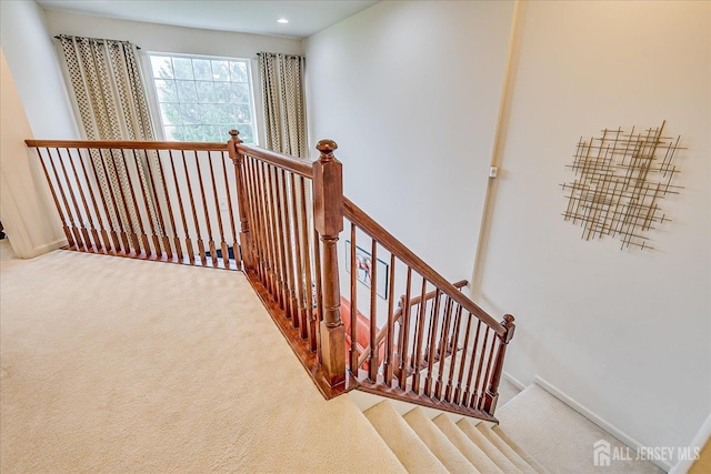 staircase featuring carpet floors, baseboards, and recessed lighting