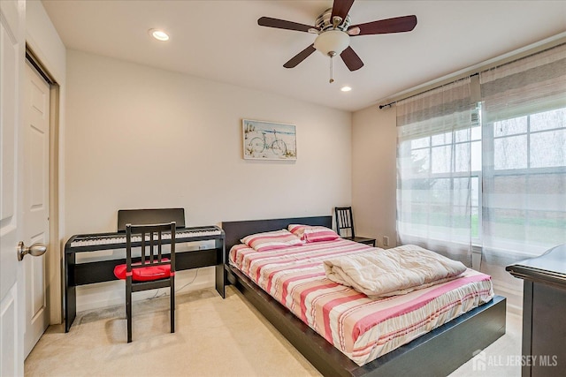 carpeted bedroom featuring recessed lighting and a ceiling fan