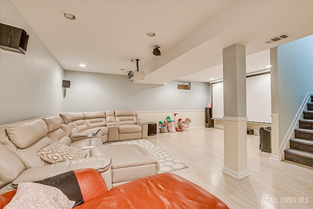 living room featuring light wood-style flooring, recessed lighting, stairs, and baseboards