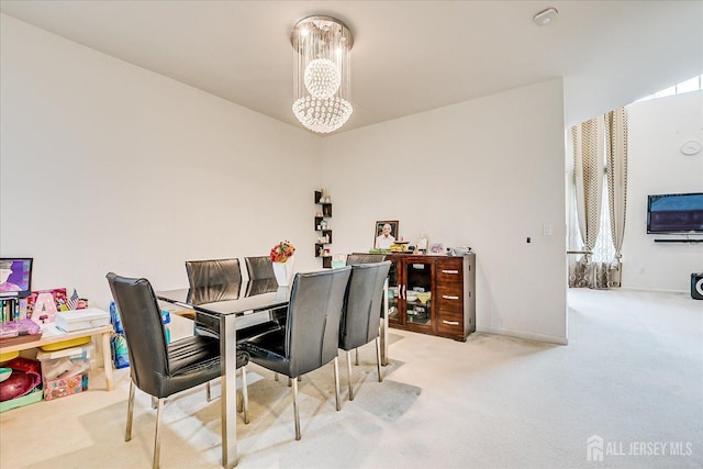 carpeted dining area with a chandelier