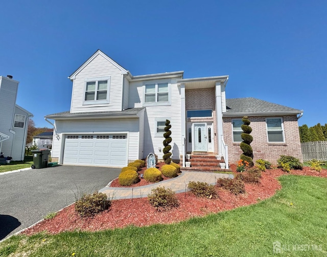 8 Woodmere Ct, Old Bridge, NJ 08857 - view of front facade with asphalt driveway, a garage, and brick siding