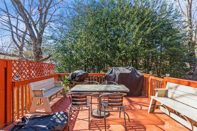 wooden deck featuring outdoor dining space and grilling area