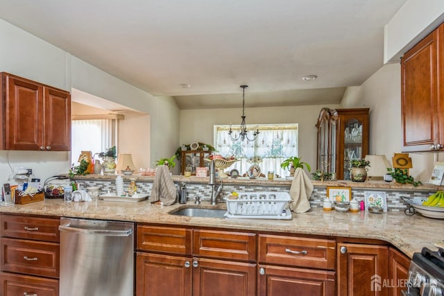 kitchen featuring a peninsula, appliances with stainless steel finishes, and light stone counters