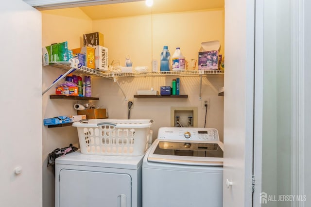 washroom featuring laundry area and separate washer and dryer