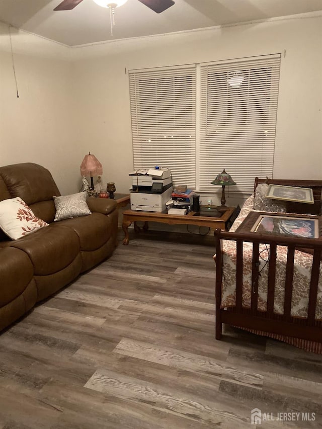 living area featuring ceiling fan and wood finished floors