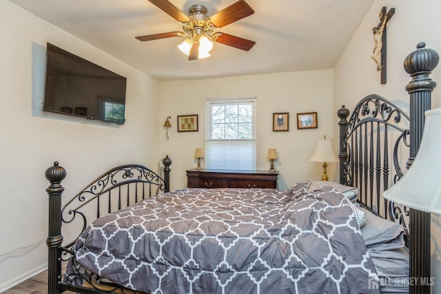 bedroom featuring baseboards, a ceiling fan, and wood finished floors