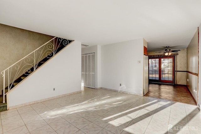 unfurnished living room with tile patterned flooring and ceiling fan