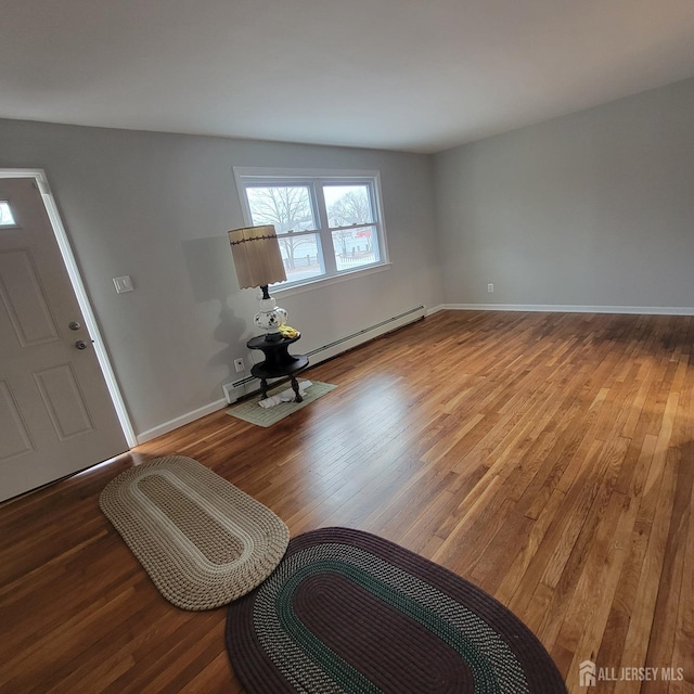 entryway featuring baseboards, wood finished floors, and baseboard heating