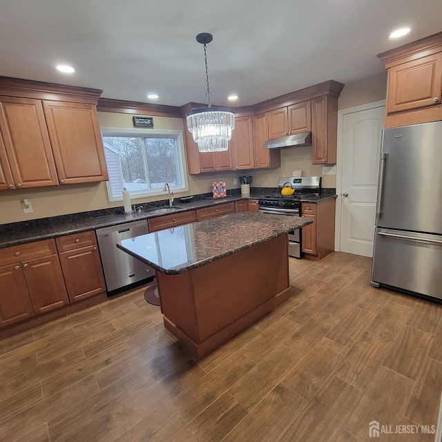 42 E Sherman St, Monroe, NJ 08831 - kitchen featuring appliances with stainless steel finishes, under cabinet range hood, a chandelier, light wood finished floors, and recessed lighting