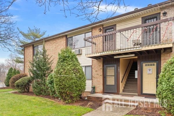 view of front of home featuring a balcony and a front yard