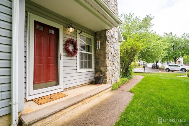 42 Haymarket Ct, East Windsor, NJ 08520 - property entrance featuring stone siding, a lawn, and a porch