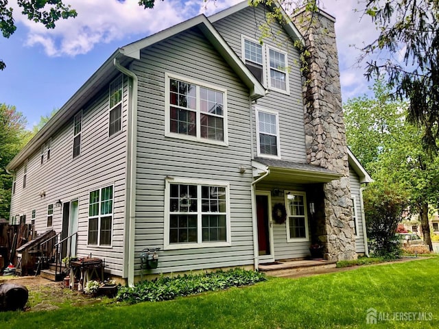 42 Haymarket Ct, East Windsor, NJ 08520 - view of front of house featuring a chimney and a front yard