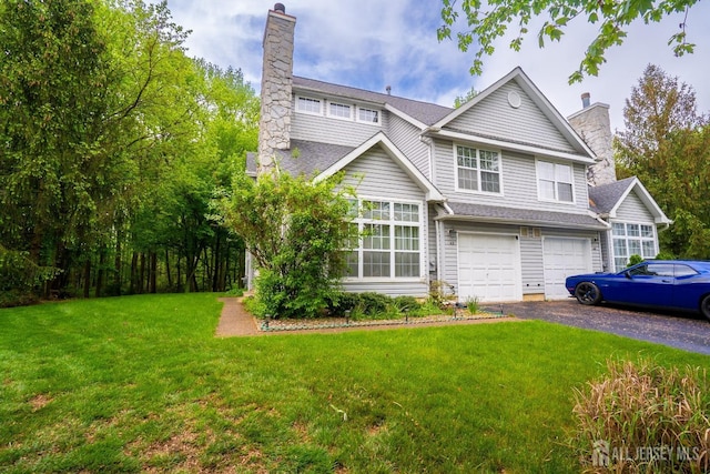 42 Haymarket Ct, East Windsor, NJ 08520 - view of front facade featuring a chimney, a garage, driveway, and a front yard
