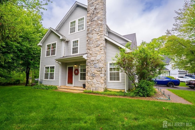 42 Haymarket Ct, East Windsor, NJ 08520 - view of front of home with a front yard and a chimney