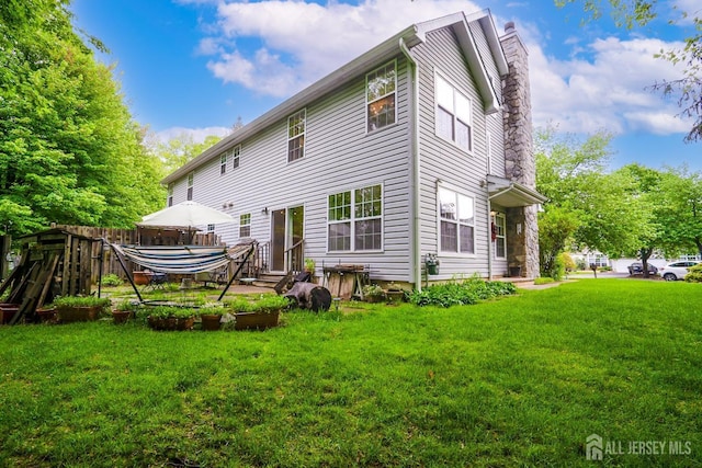 42 Haymarket Ct, East Windsor, NJ 08520 - rear view of house featuring a chimney, a yard, and entry steps