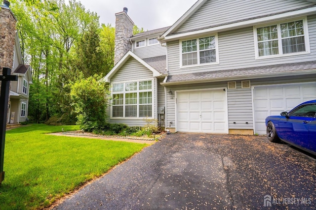 42 Haymarket Ct, East Windsor, NJ 08520 - traditional home featuring a front yard, asphalt driveway, a garage, and a chimney
