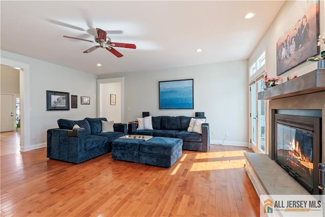 11 Hilltop Blvd N, East Brunswick, NJ 08816 - living area with light wood-type flooring, a glass covered fireplace, ceiling fan, recessed lighting, and baseboards