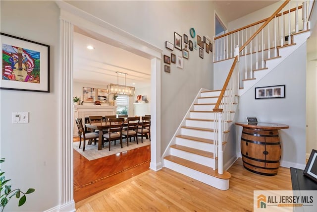 11 Hilltop Blvd N, East Brunswick, NJ 08816 - stairs featuring wood finished floors, baseboards, and a chandelier