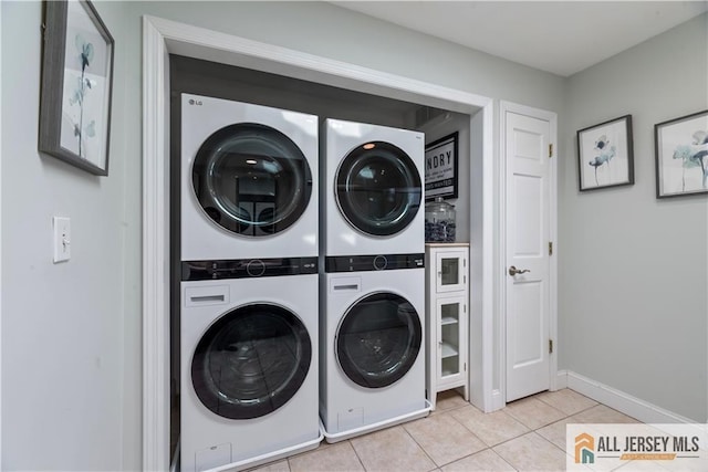 11 Hilltop Blvd N, East Brunswick, NJ 08816 - laundry area with stacked washing machine and dryer, light tile patterned flooring, and baseboards