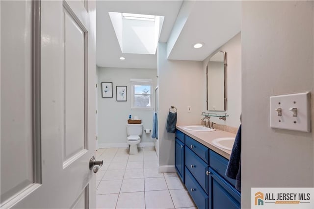 11 Hilltop Blvd N, East Brunswick, NJ 08816 - full bath with a skylight, double vanity, tile patterned flooring, toilet, and baseboards