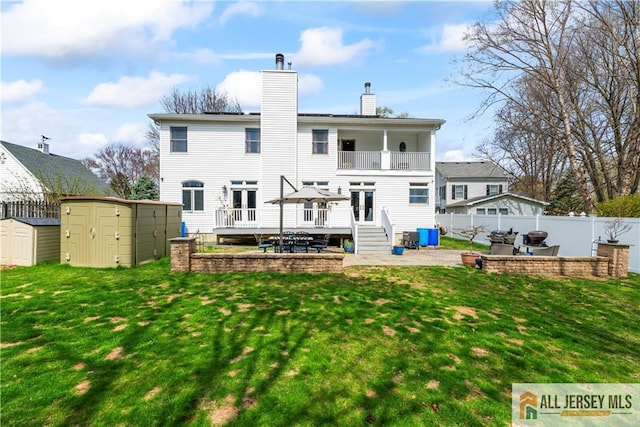 11 Hilltop Blvd N, East Brunswick, NJ 08816 - rear view of property featuring a balcony, a chimney, a wooden deck, french doors, and a patio area