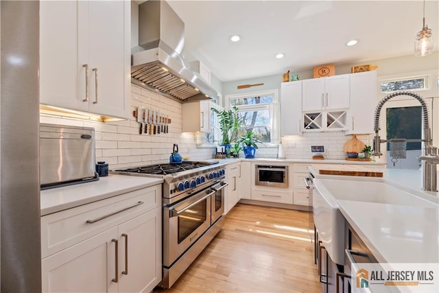 11 Hilltop Blvd N, East Brunswick, NJ 08816 - kitchen with ventilation hood, double oven range, a sink, light countertops, and white cabinetry
