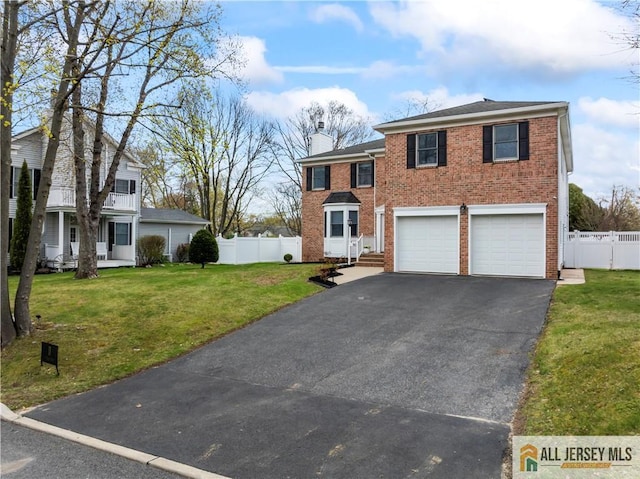 11 Hilltop Blvd N, East Brunswick, NJ 08816 - traditional-style home featuring driveway, a chimney, a garage, and brick siding