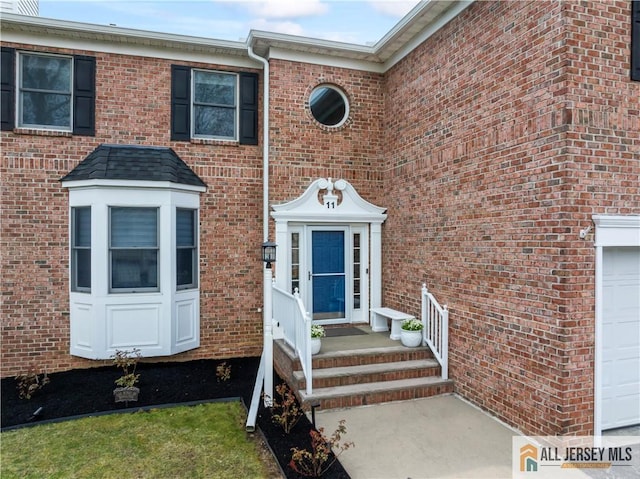 11 Hilltop Blvd N, East Brunswick, NJ 08816 - entrance to property featuring a garage and brick siding