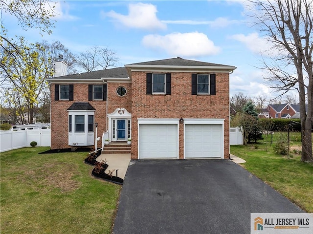 11 Hilltop Blvd N, East Brunswick, NJ 08816 - view of front of house featuring a chimney, driveway, brick siding, and a garage