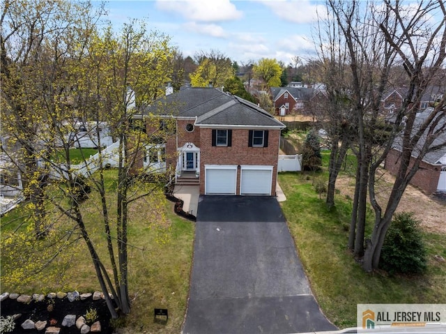 11 Hilltop Blvd N, East Brunswick, NJ 08816 - view of front of property with driveway, brick siding, an attached garage, and a front lawn