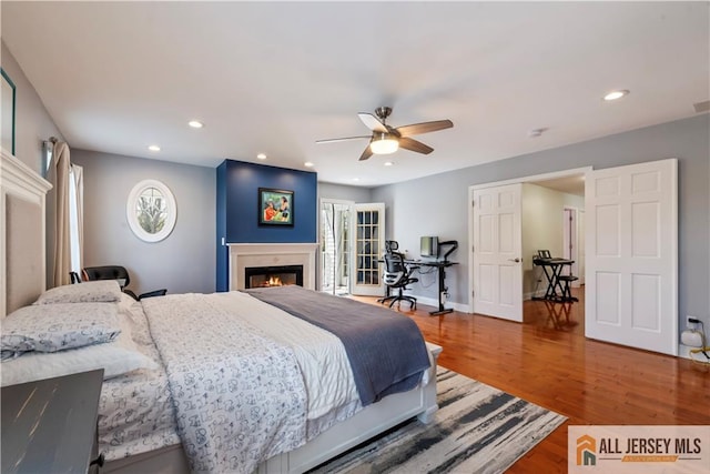 11 Hilltop Blvd N, East Brunswick, NJ 08816 - bedroom with a glass covered fireplace, wood finished floors, recessed lighting, ceiling fan, and an office area