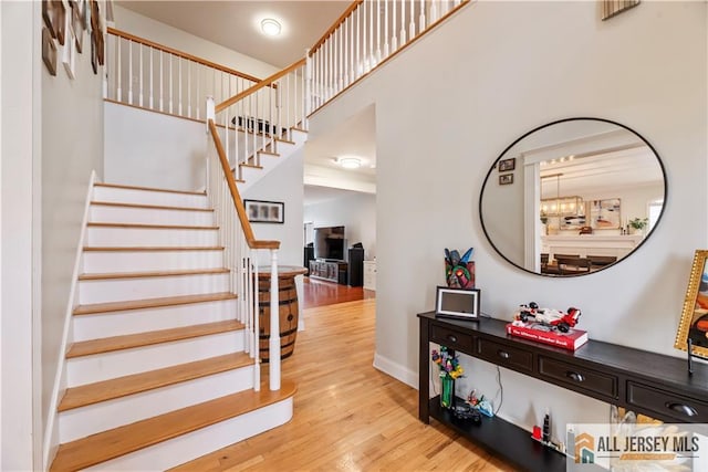 11 Hilltop Blvd N, East Brunswick, NJ 08816 - staircase featuring wood finished floors, a high ceiling, and baseboards