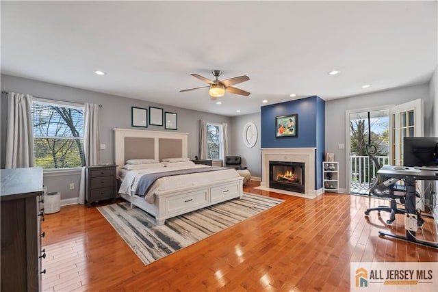 11 Hilltop Blvd N, East Brunswick, NJ 08816 - bedroom featuring access to exterior, wood finished floors, a fireplace with flush hearth, baseboards, and recessed lighting