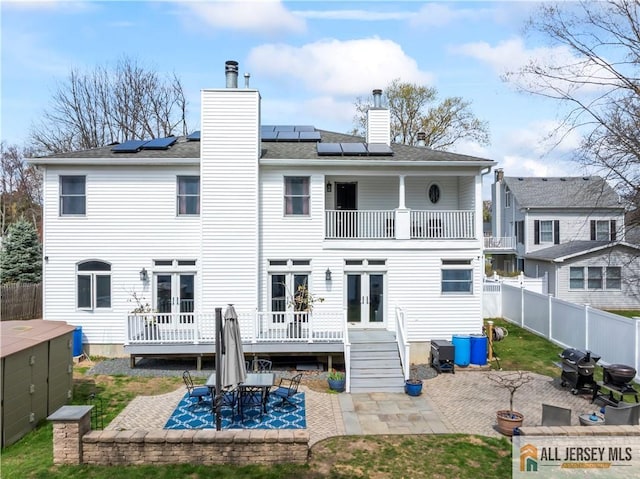 11 Hilltop Blvd N, East Brunswick, NJ 08816 - back of house featuring french doors, a balcony, a patio area, and a chimney