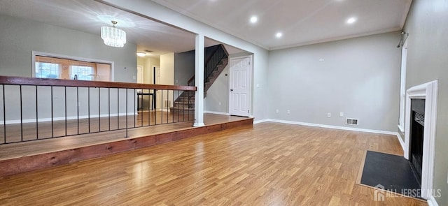 2003 Timber Oaks Rd, Edison, NJ 08820 - unfurnished living room with wood finished floors, a fireplace with flush hearth, stairs, a chandelier, and recessed lighting
