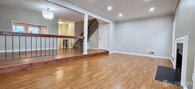 2003 Timber Oaks Rd, Edison, NJ 08820 - unfurnished living room featuring wood finished floors, a fireplace with flush hearth, stairway, recessed lighting, and a chandelier