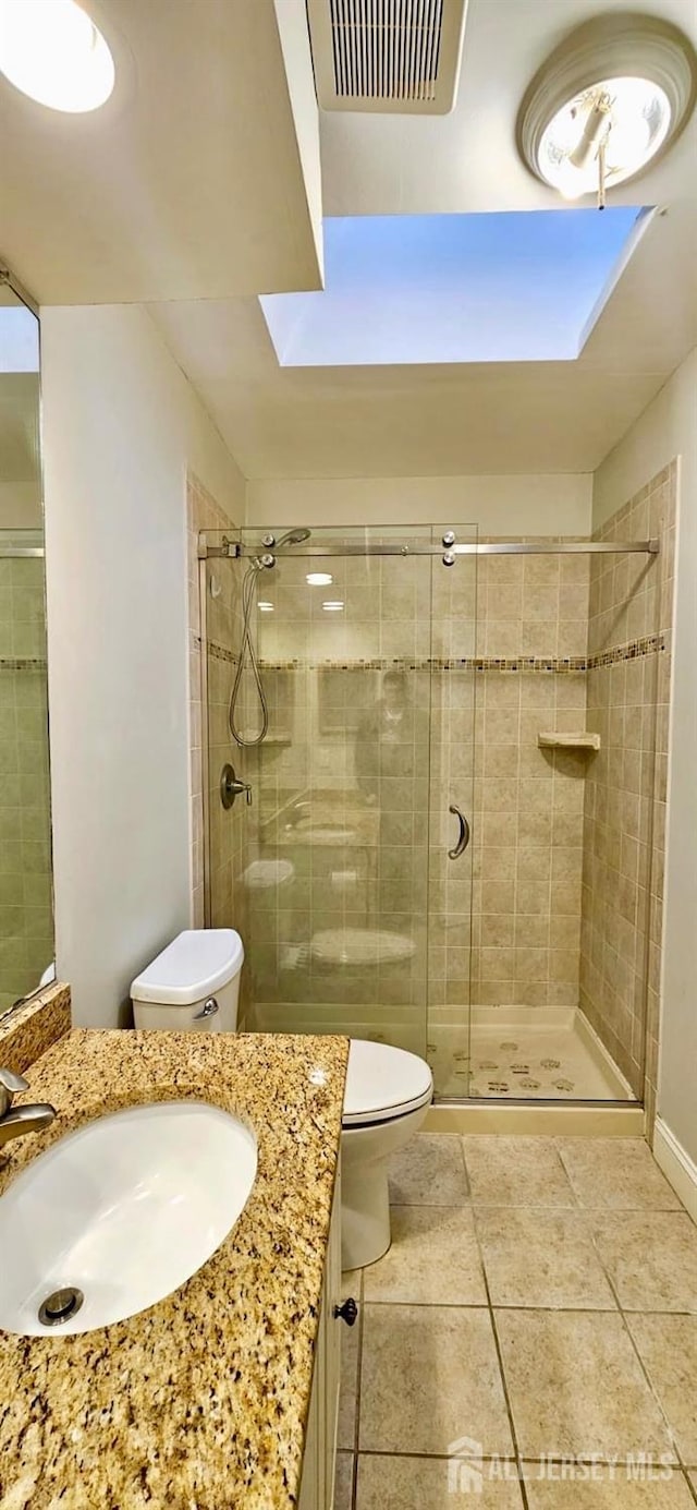 2003 Timber Oaks Rd, Edison, NJ 08820 - bathroom featuring vanity, a shower stall, tile patterned floors, and a skylight