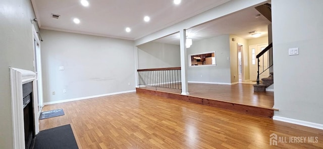 2003 Timber Oaks Rd, Edison, NJ 08820 - unfurnished living room with a fireplace with flush hearth, wood finished floors, recessed lighting, and stairs