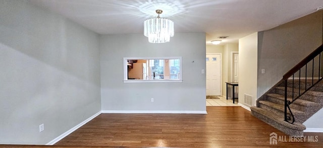 2003 Timber Oaks Rd, Edison, NJ 08820 - spare room with wood finished floors, stairs, and a chandelier