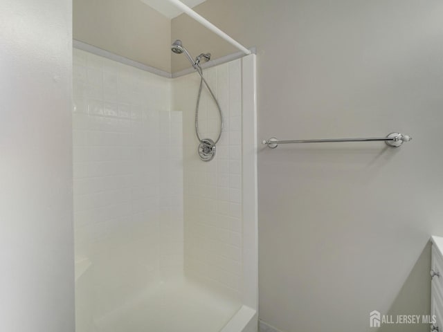 full bath with a tile shower